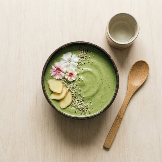 Green matcha smoothie bowl topped with fruit and granola